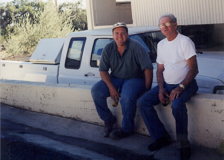Two men sitting on a curb