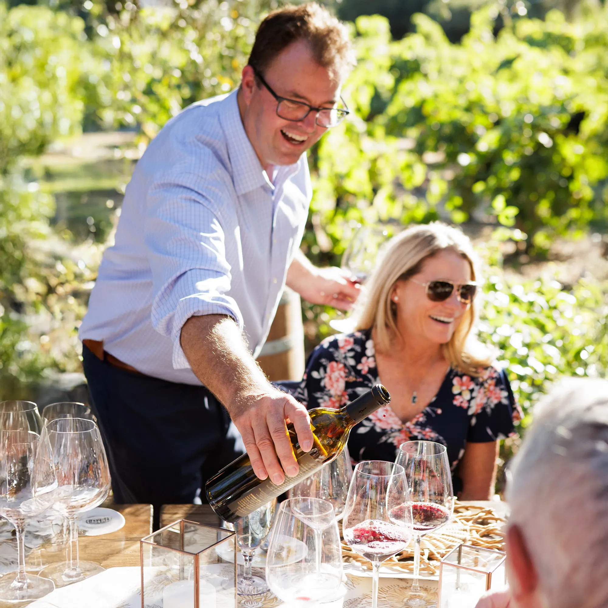 Bill Nancarrow pouring wine for a guest at Regusci's winemaker Dinner